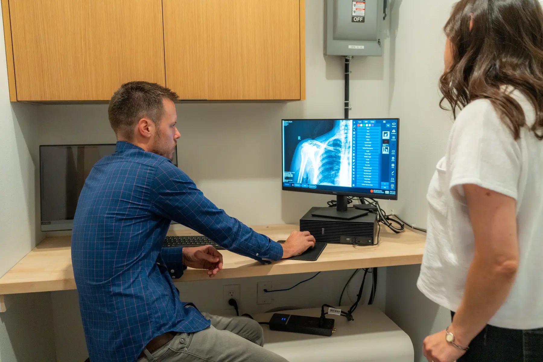 Dr. Michael Moss reviewing digital X-rays with a patient